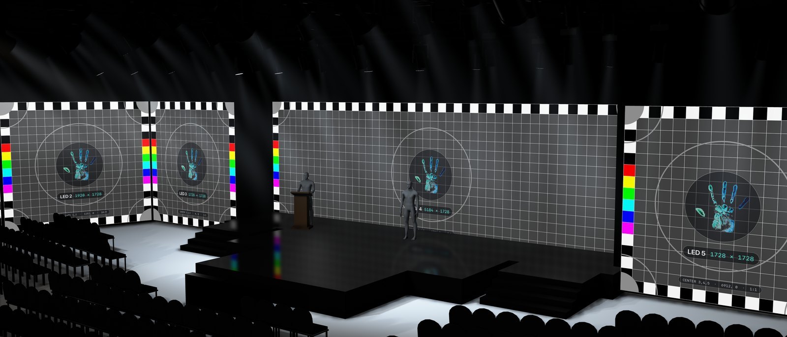 PreViz from a side seat: every LED wall showing its own Millumin-style test card with the CVH Visuals hand at its center, the walls and presenters reflected in the stage deck
