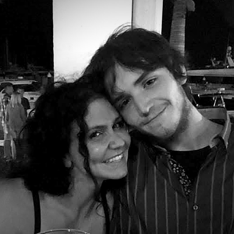 Black-and-white photo of Isaiah and his mom, smiling with their heads resting together