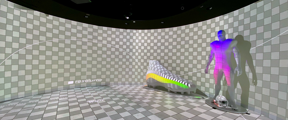 Product reveal with a sneaker and figure lit by projection inside a checkerboard-mapped room